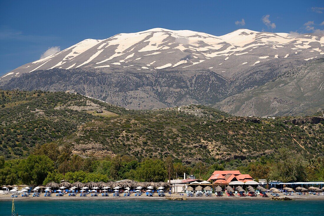 Greece, Crete, Agia Galini, Paralia Agia Galini, beach with Mount Ida (or Mount Psiloritis) rising to 2,456 meters