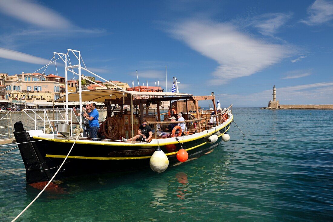 Greece, Crete, Chania, venetian port, pleasure boat going to the lighthouse