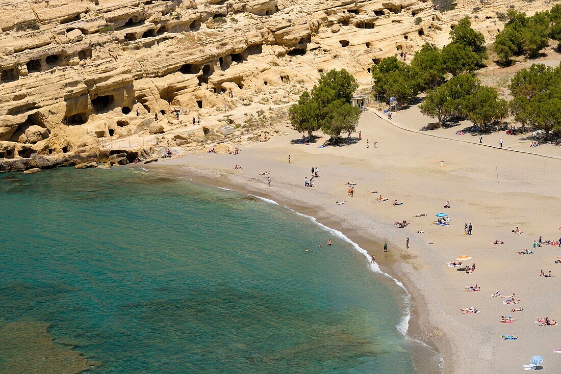 Greece, Crete, Matala, Matala Bay, beach and caves seen from the south cliff