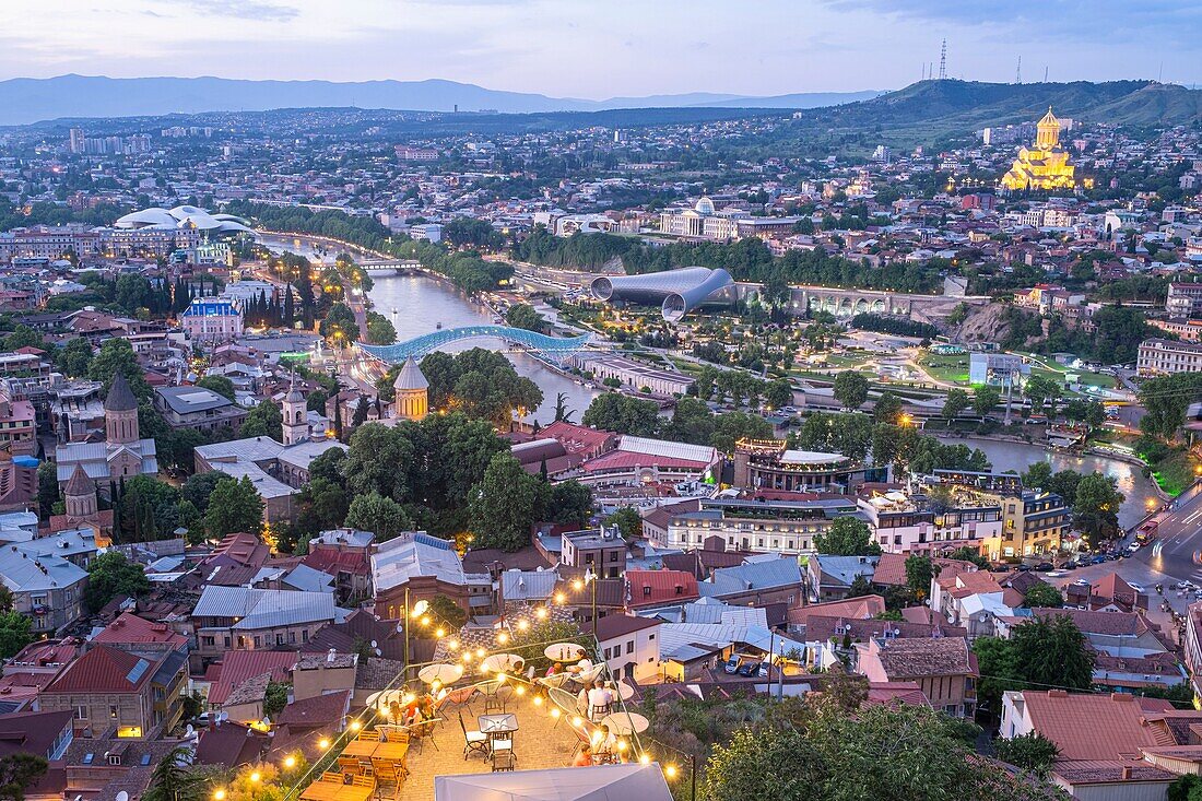 Georgia, Tbilisi, panorama from Narikala fortress, Old Town and Bridge of Peace over the Koura river, the Holy Trinity Cathedral (or Tsminda Sameba) in the background