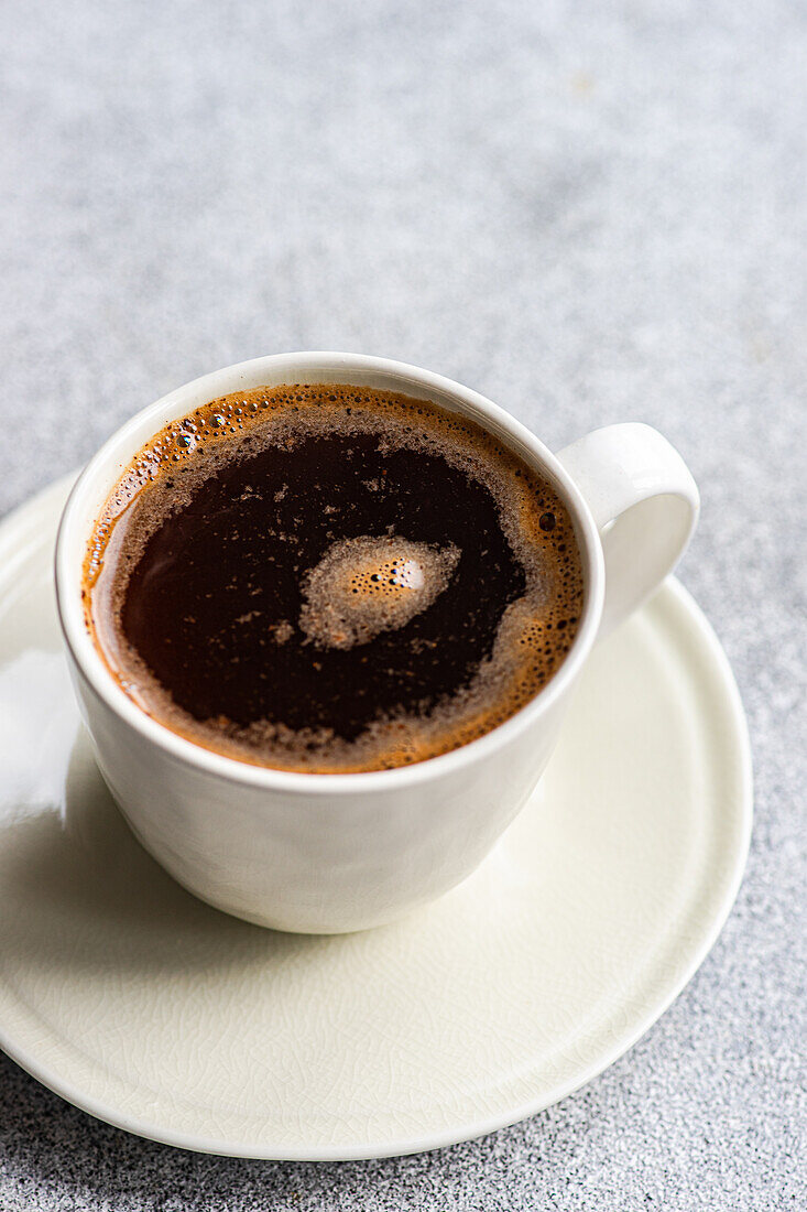 From above image showcasing a steaming cup of freshly brewed coffee, perfect for a rejuvenating morning start.