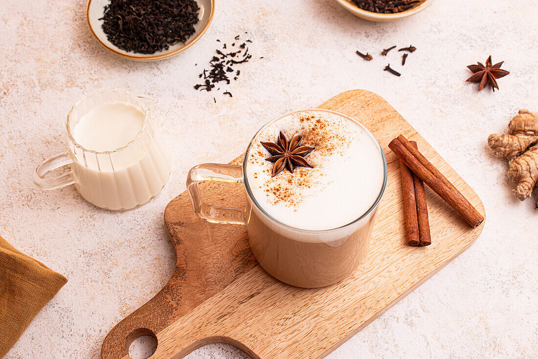 From above, Delicious chai latte with creamy foam and star anise in rustic style