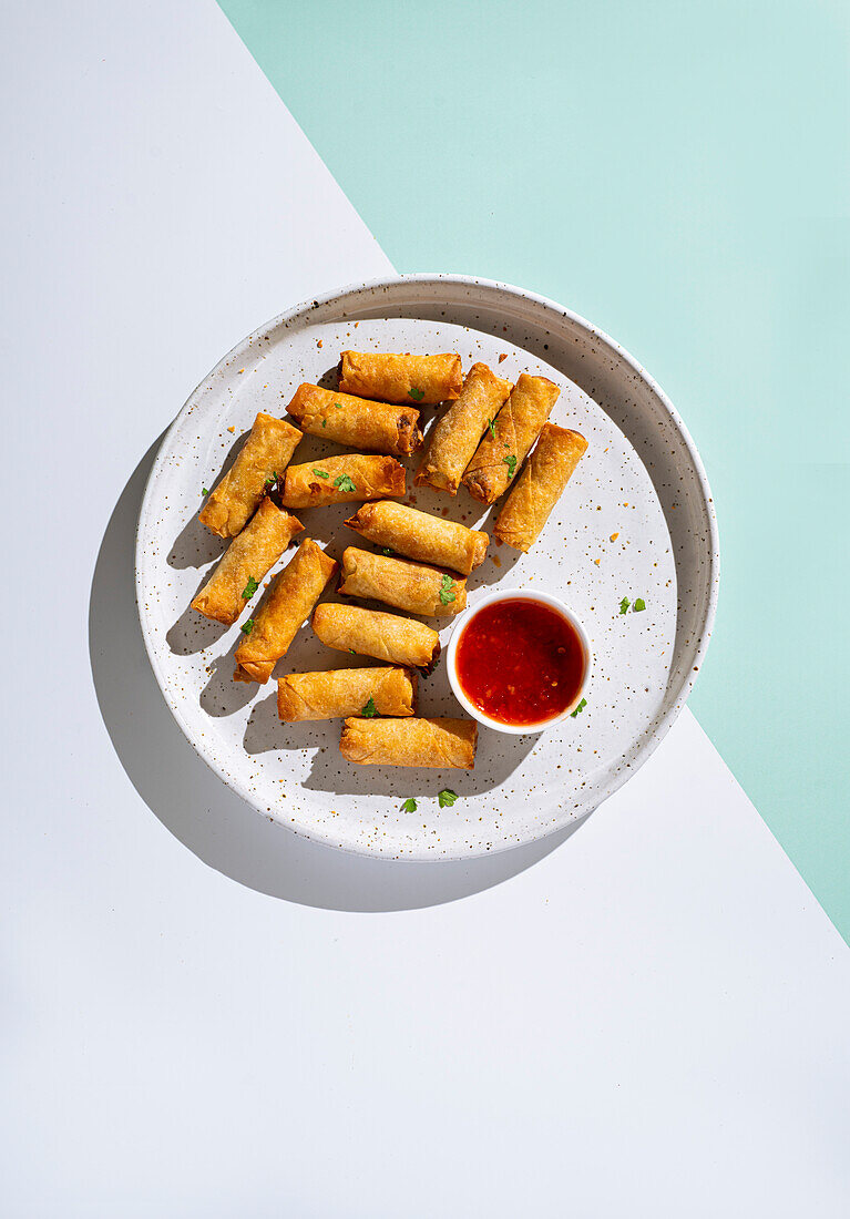 A Plate of Crispy Spring Rolls on a Pastel Backdrop