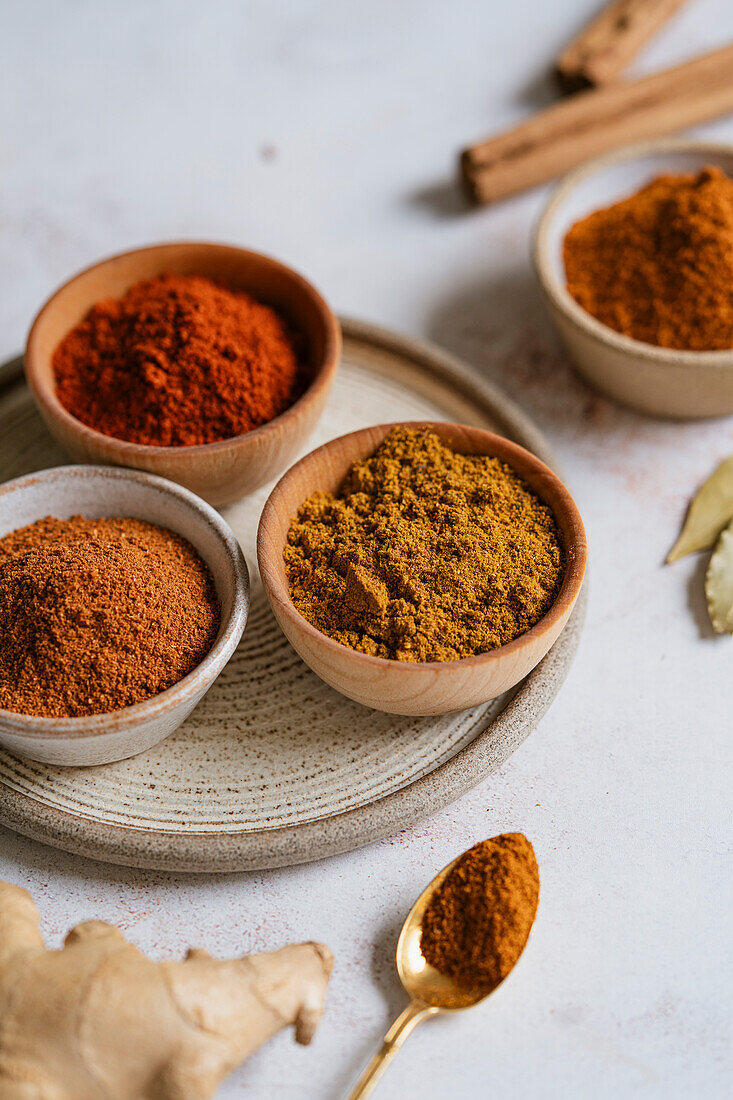 Ground spices in bowls on a neutral background