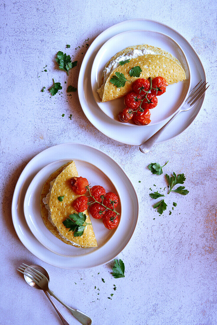 Glutenfreie Crepes mit Kräuter-Ricotta und gebratenen Rispentomaten.