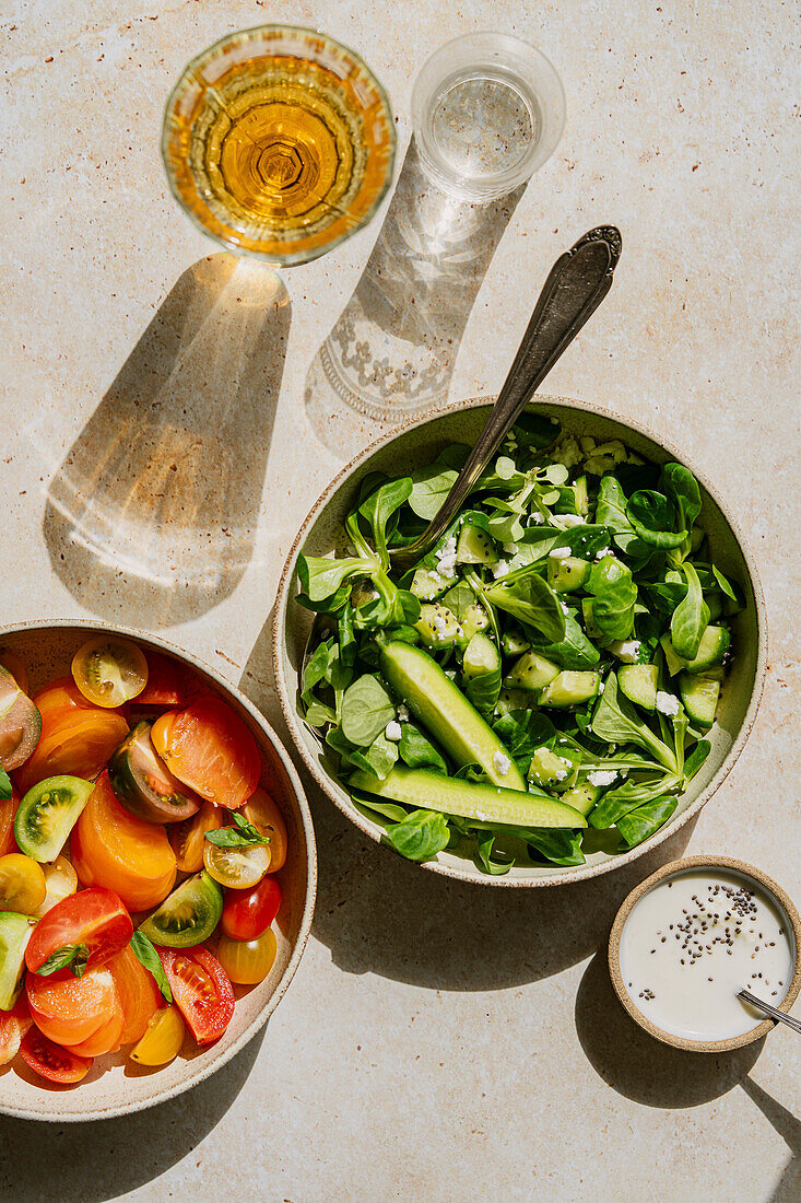 Summer salads in hard light on a stone background