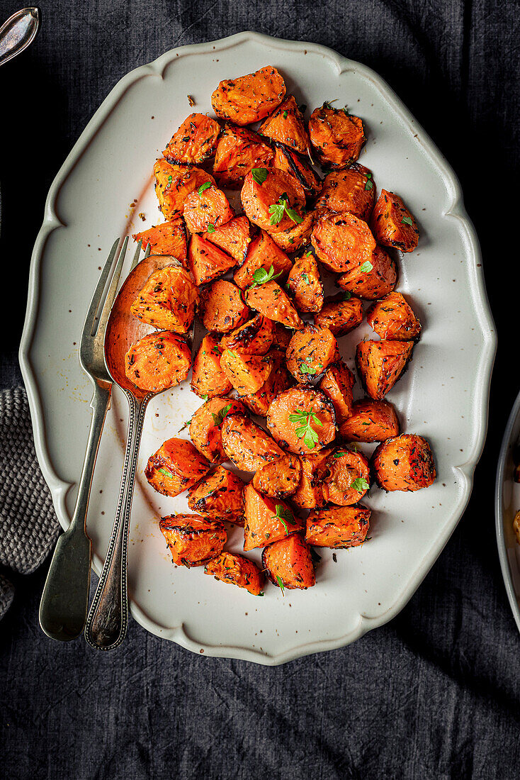 roasted carrrots on a white serving plate