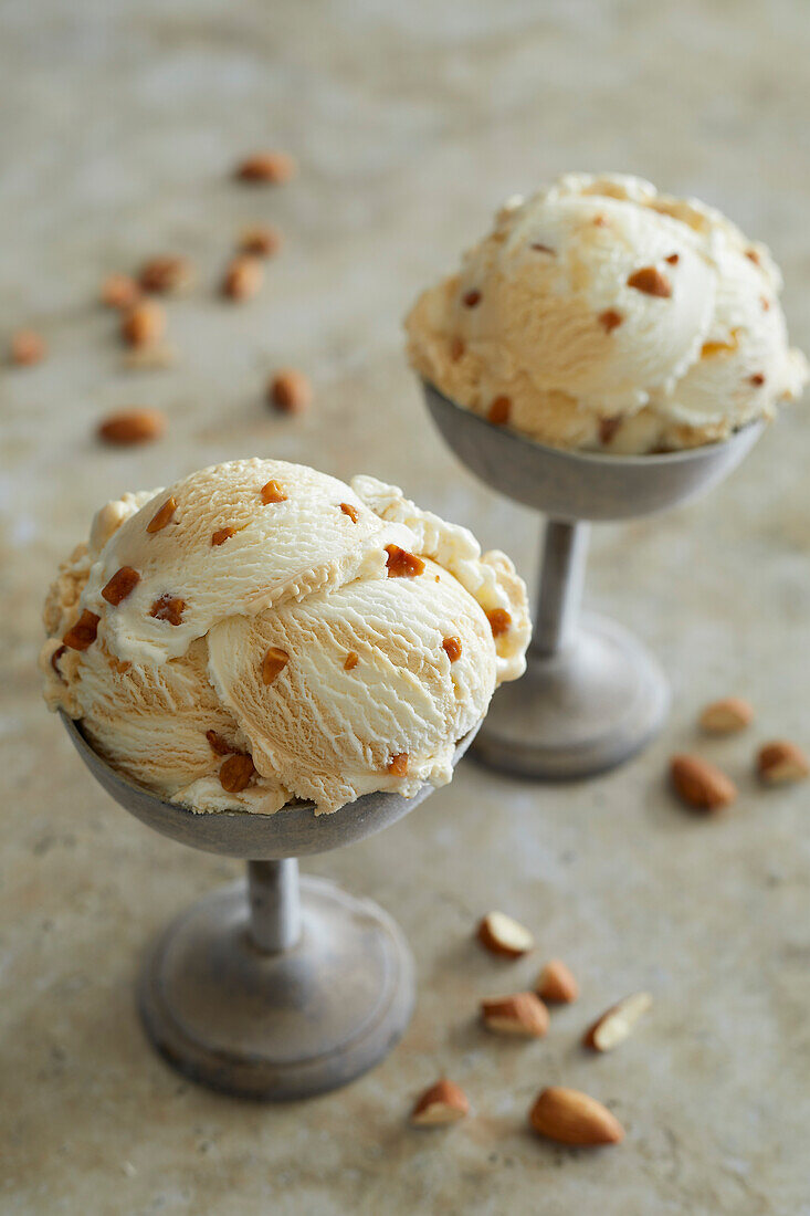 Almond ice cream with caramel pieces in a cup