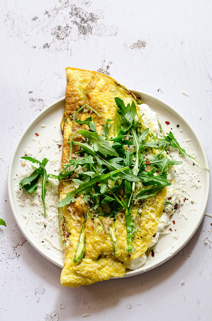 Frittata with asparagus and fresh ricotta, served with rocket