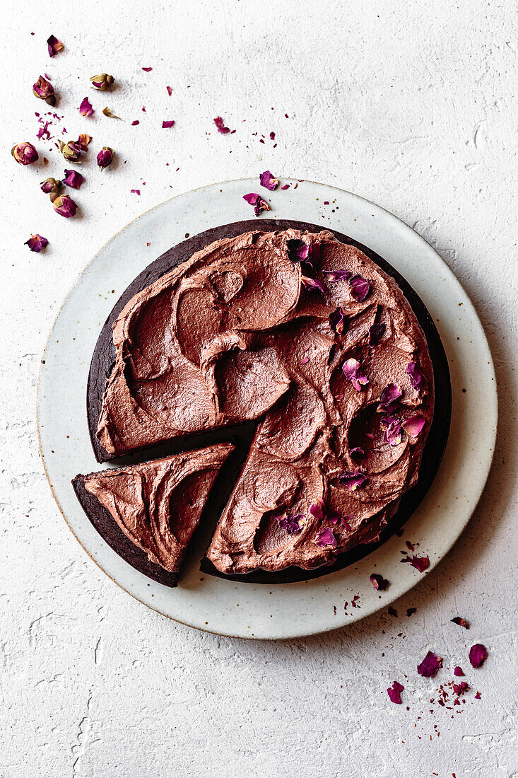 Chocolate cake with chocolate frosting and dried rose petals