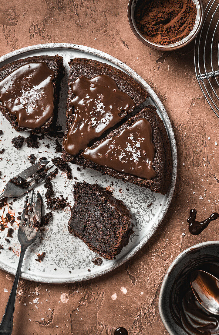 Chocolate cake with chocolate icing on a brown background