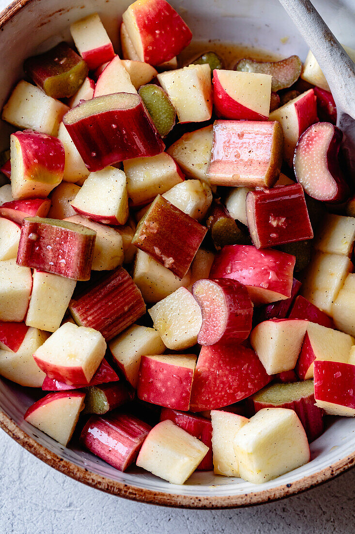 Apple and rhubarb crumble ingredients in a bowl