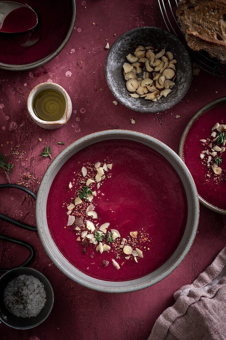 Beetroot soup bowl on red surface