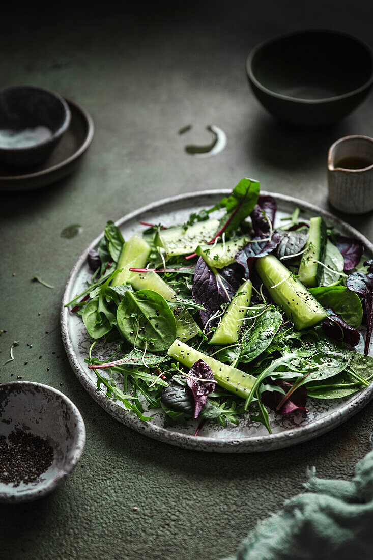 Cucumber salad on a dark green backdrop