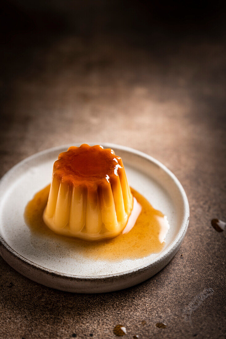 Caramel panna cotta on a brown surface