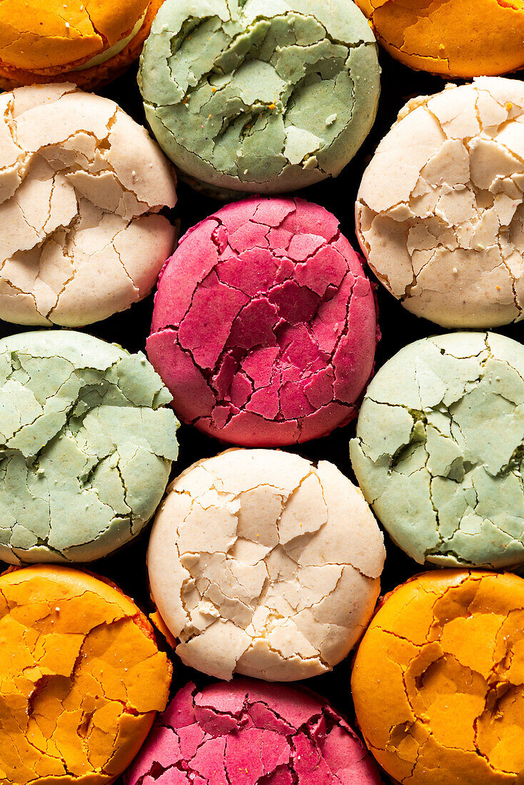 Close-up of multi-coloured cracked macaroons