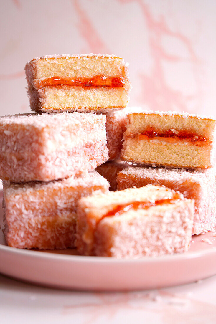 Australian Pink Lamington Small Square Cakes Sandwiched with Strawberry Jam and Coated in Coconut.