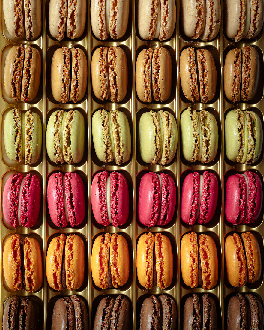 Rows of colourful macarons in packaging