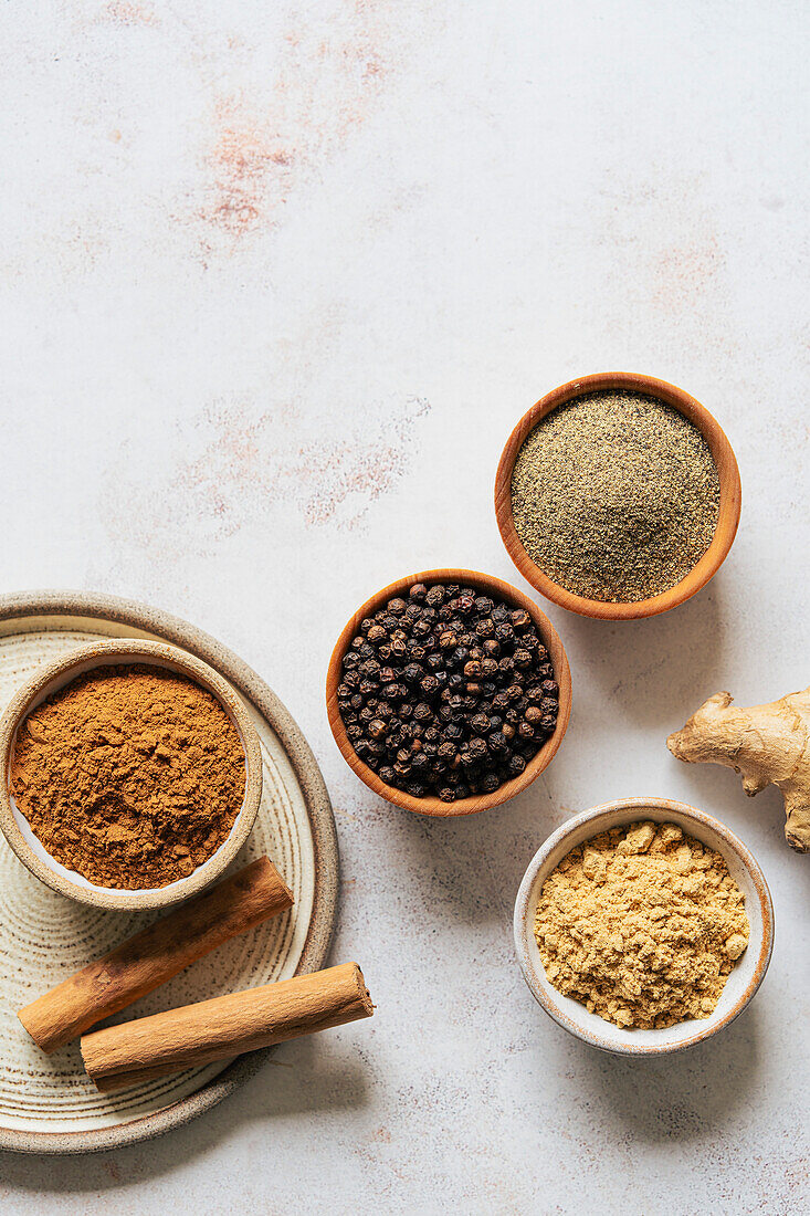 Ground spices in bowls on a neutral background