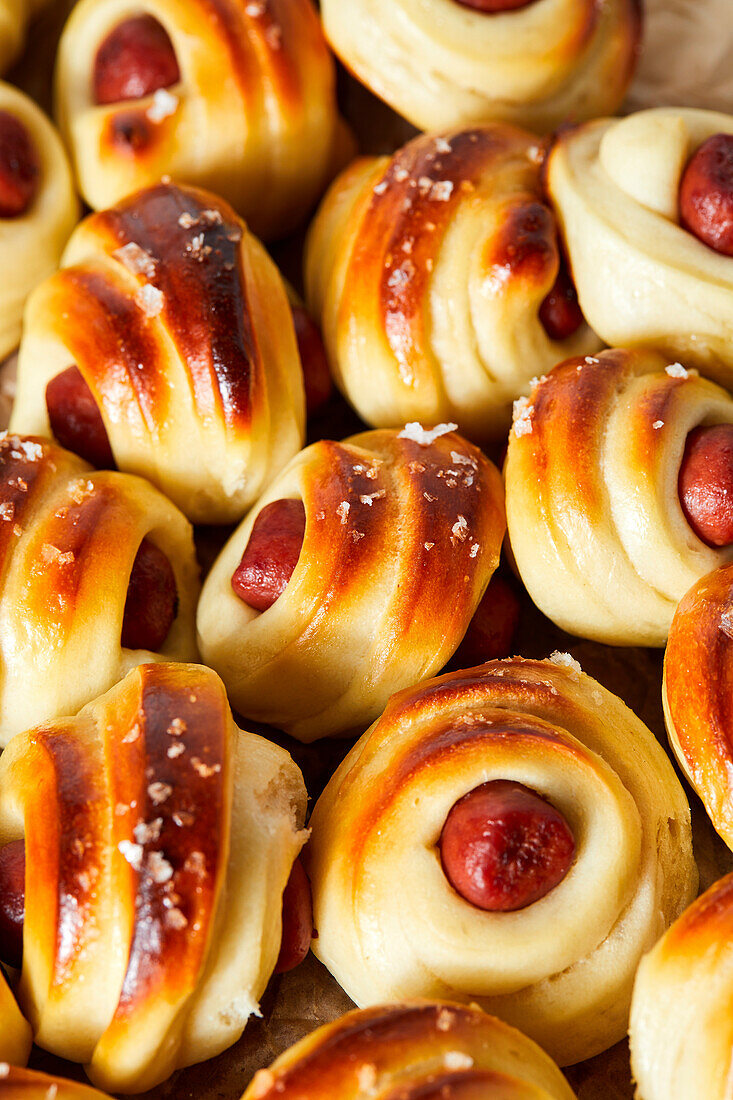 Sausages in a pastry coat on kraft paper.