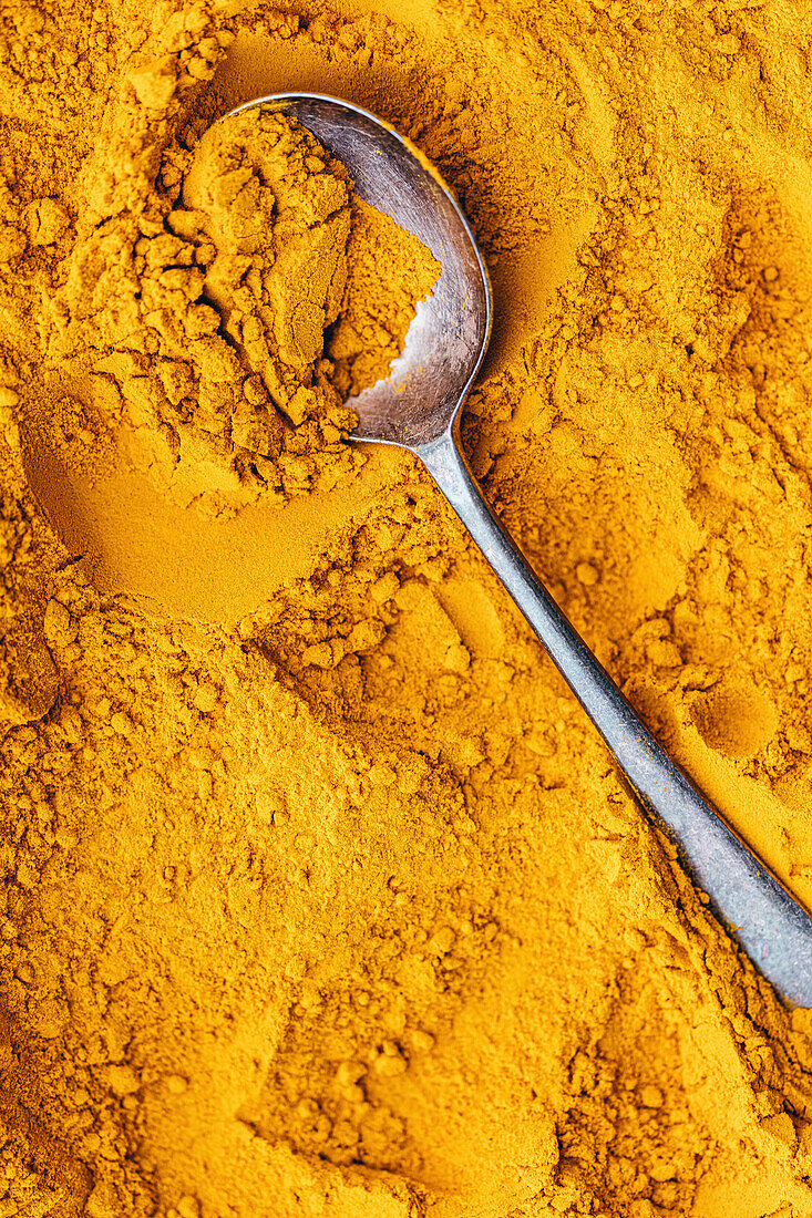 Golden Turmeric with a spoon