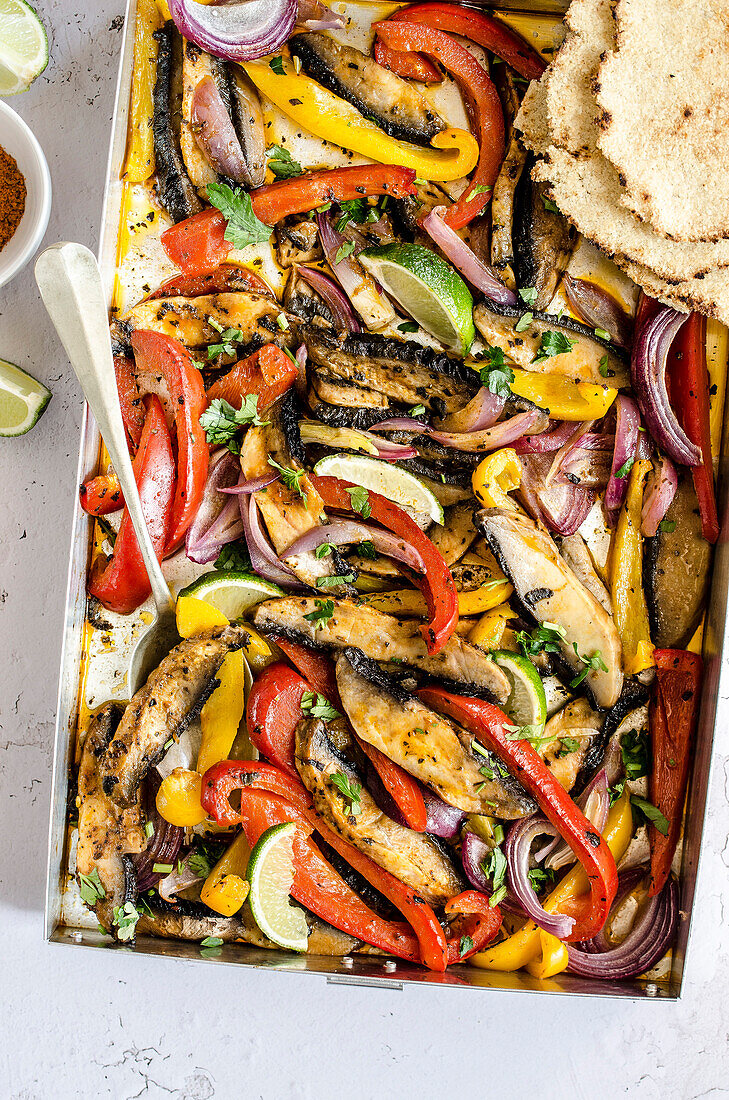 Fajitas with portobello mushrooms and bell pepper, avocado and tortillas