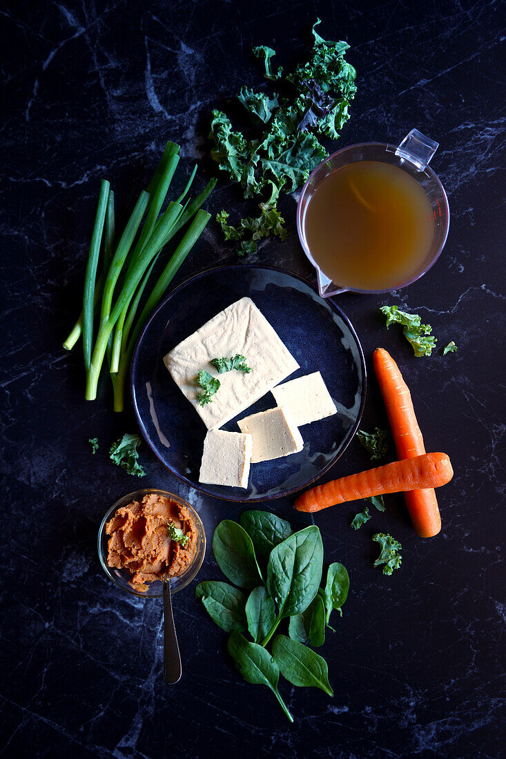 Rustic Okinawan-style miso soup, raw ingredients.