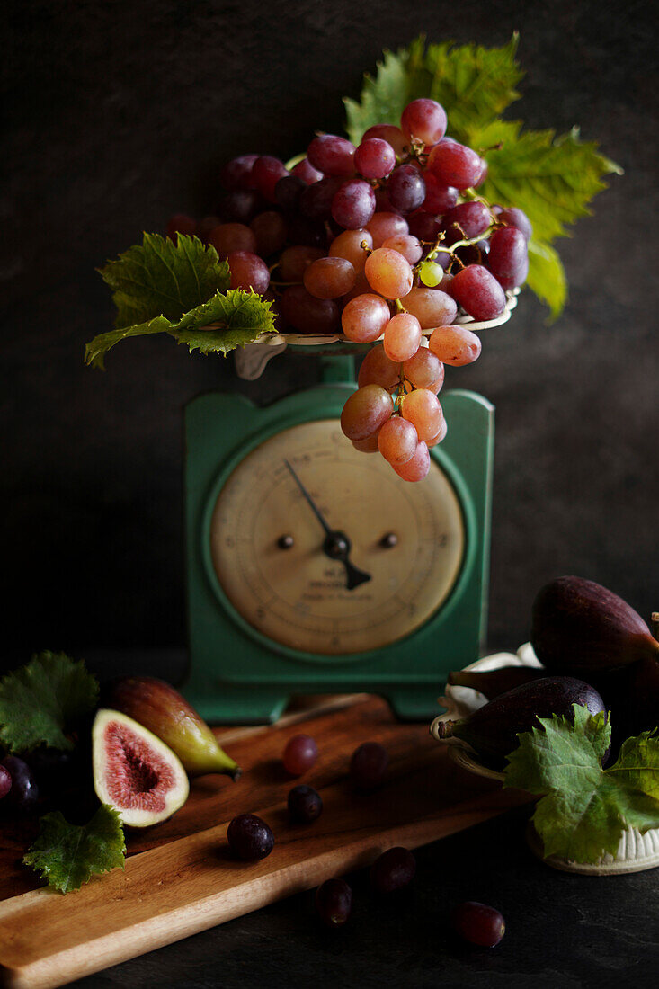 Figs and grapes with vintage kitchen scales.