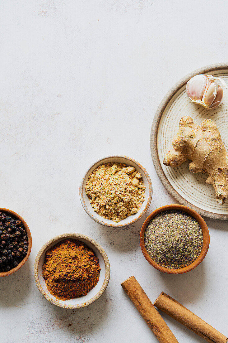 Ground spices in bowls on a white background