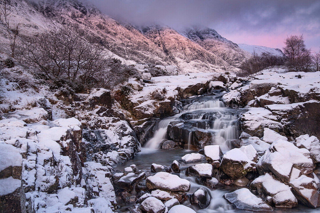 Last light on Clachaig Falls backed by Aonach Eagach and Meal Dearg in winter, Glencoe, Scottish Highlands, Scotland, United Kingdom, Europe