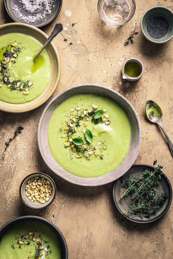 Green soup with herbs on a brown background