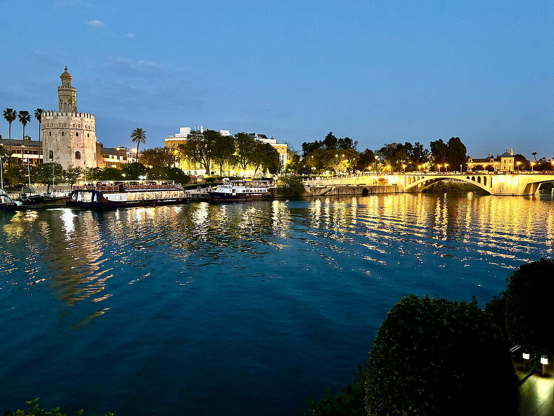 Sunset view of the Guadalquivir River with the Torre del Oro (Tower of Gold), a dodecagonal military watchtower erected by the Almohad Caliphate, Seville, Andalusia, Spain, Europe