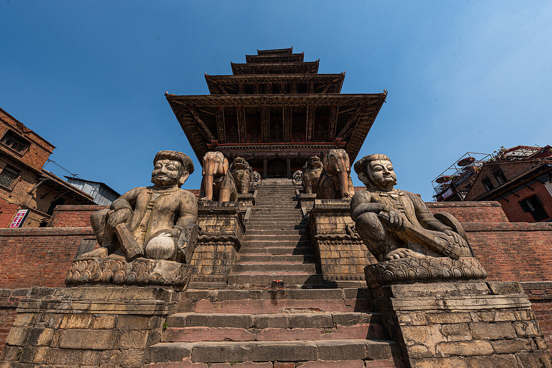 Stone steps and guarding statues at the main pagoda of Nyatapola Temple, UNESCO World Heritage Site, Bhaktapur, Kathmandu Valley, Nepal, Asia