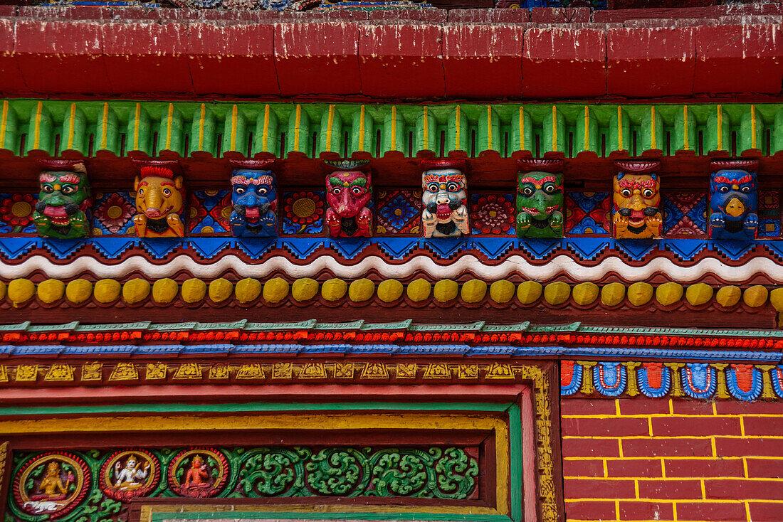 Detail of colorful wood carved faces of Changu Narayan Temple, Nepal, Asia