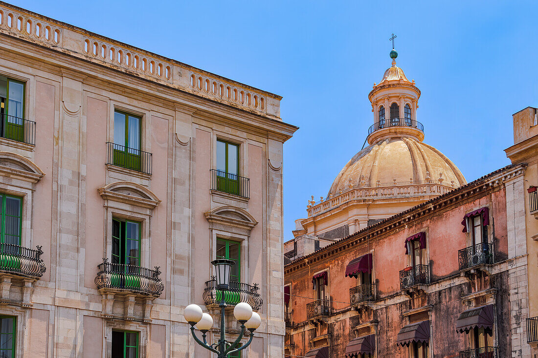 Abbey of St. Agatha cupola behind historic buildings with iron balconies in Catania, Sicily, Italy, Mediterranean, Europe