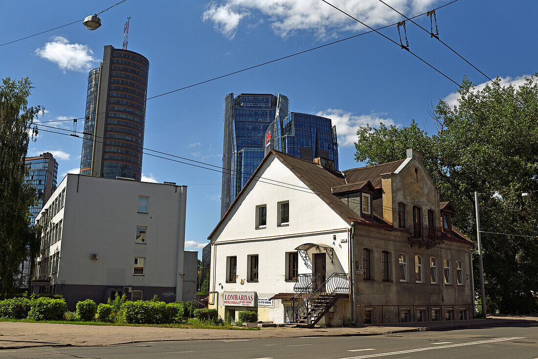 Old house dating from 1879, surrounded by modern office towers in the Snipiskes district, Vilnius, Lithuania, Europe