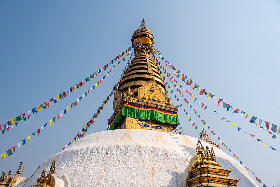 Blue sky and prayer flags at the large Swayambhu (Swayanbhunath) Stupa, UNESCO World Heritage Site, Kathmandu, Nepal, Asia