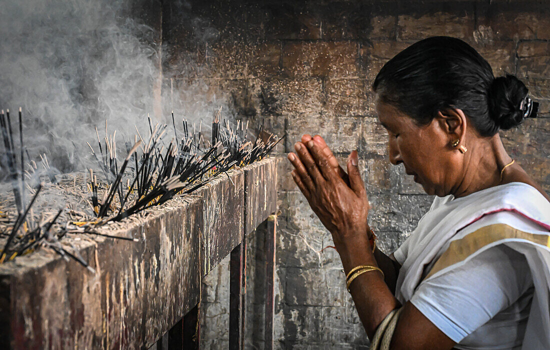 Woman praying, incense sticks, Kamakhya Temple, Guwahati, Assam, India, Asia