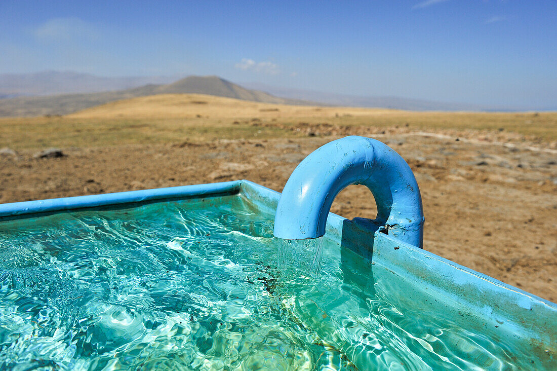 Watering place on the Argitchi plateau, Armaghan volcano in the background, Gegharkunik region, Armenia, Eurasia