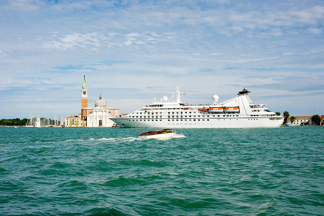 A cruise ship in the lagoon passing in front of San Marco Giardinetti seen from Punta della Dogana, Venice, UNESCO World Heritage Site, Veneto, Italy, Europe