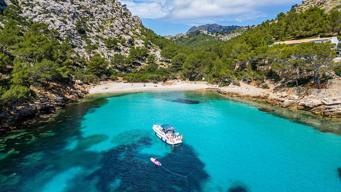 Aerial of a little motorboat in a bay on the Formentor Peninsula, Mallorca, Balearic islands, Spain, Mediterranean, Europe