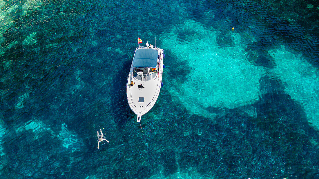 Aerial of a little motorboat in a bay on the Formentor Peninsula, Mallorca, Balearic islands, Spain, Mediterranean, Europe