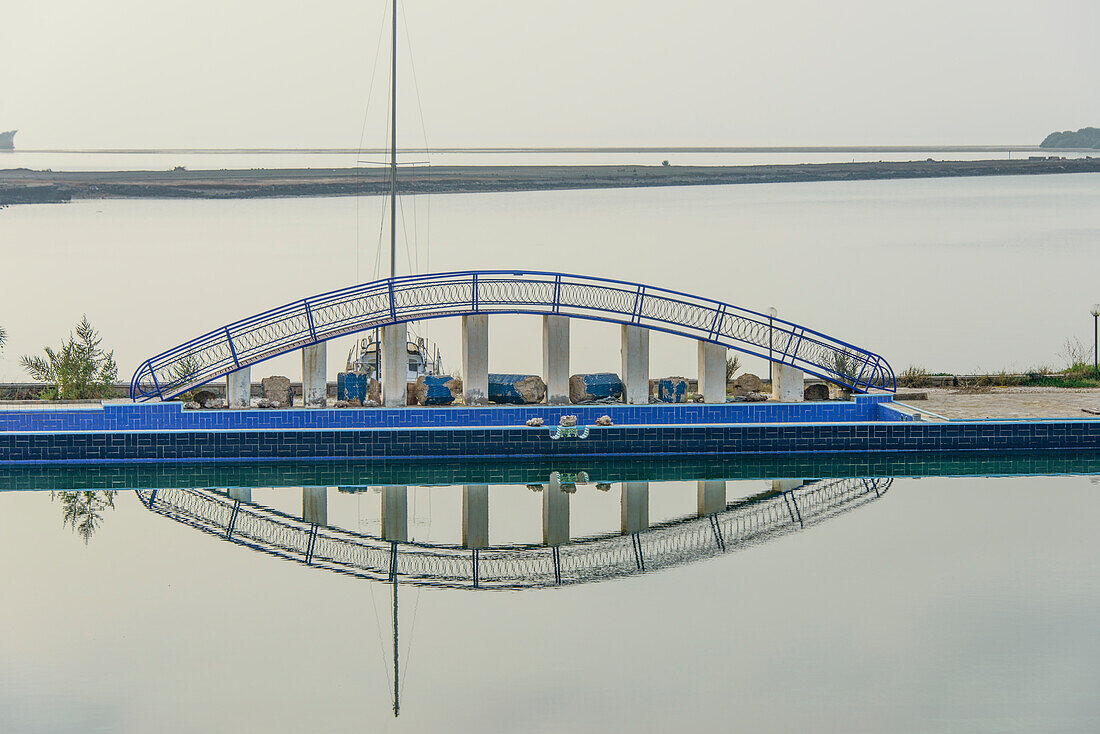 Reflections of a little bridge in a luxury hotel in the old port town of Massawa, Eritrea, Africa