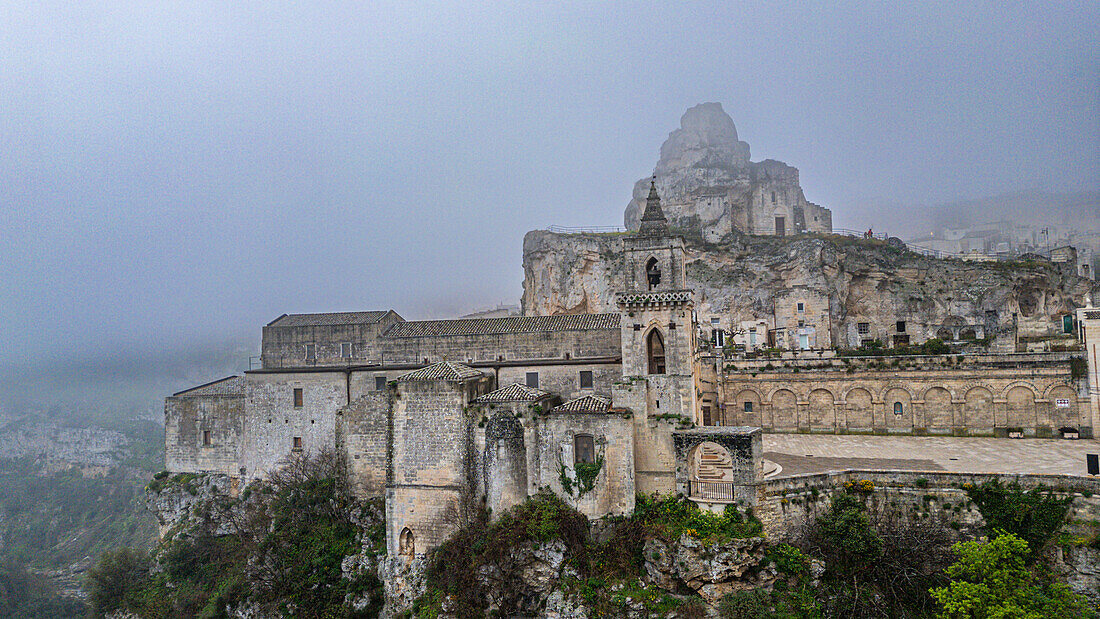 Aerial of the Sassi di Matera in fog, UNESCO World Heritage Site, Basilicata, Italy, Europe