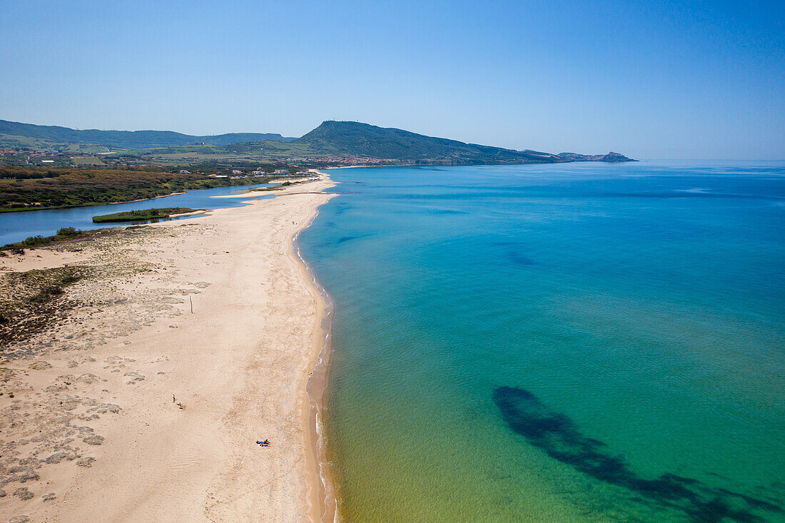 Drone aerial view of San Pietro a Mare wild beach coast with Castelsardo in the background, Sardinia, Italy, Mediterranean, Europe