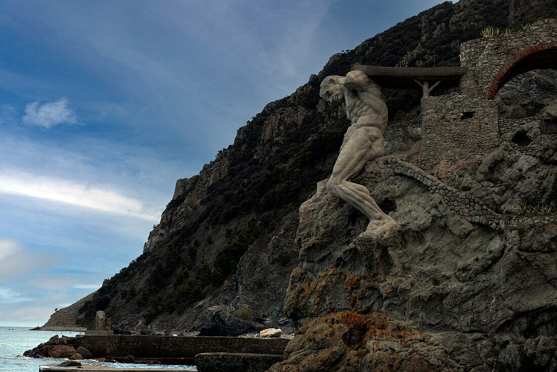 Il Gigante, eine Steinskulptur, die Neptun, den römischen Gott des Meeres, darstellt, am Ende des Strandes Fegina, Monterosso al Mare, Cinque Terre, UNESCO-Welterbe, Ligurien, Italien, Europa.