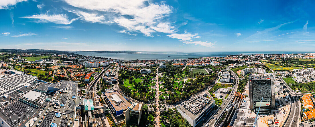 Aerial drone panoramic view of Parque dos Poetas, 25 hectare parkland with 60 statues in honour of 60 poets, Oeiras, Lisbon, Portugal, Europe