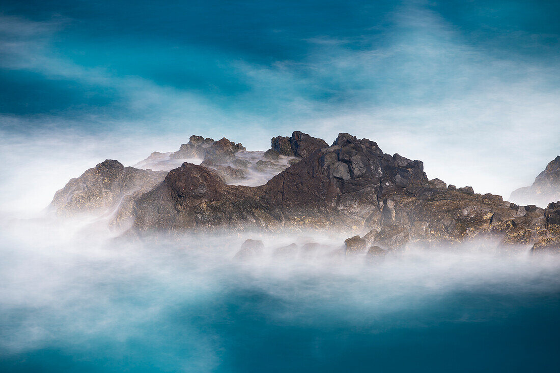 Aerial view of small rock island amongst waves, Madeira, Portugal, Atlantic, Europe