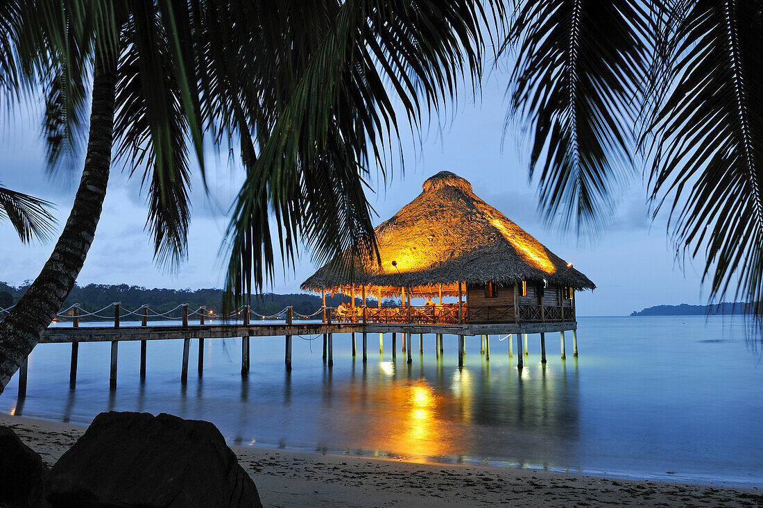 Bar and restaurant on stilts at dusk, Playa Tortuga hotel, Colon Island, Bocas del Toro Archipelago, Republic of Panama, Central America