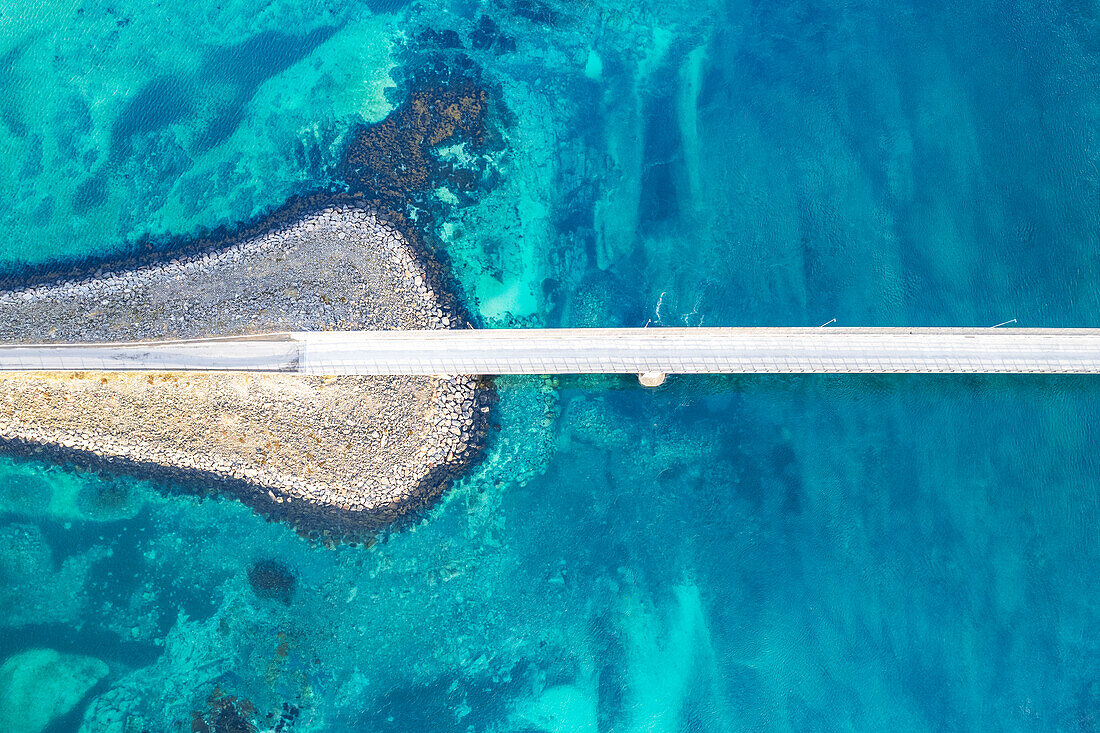 Aerial view of the bridge linking islands crossing the fjord with turquoise Arctic water, Flakstadburene, Fredvang, Lofoten Islands, Norway, Scandinavia, Europe